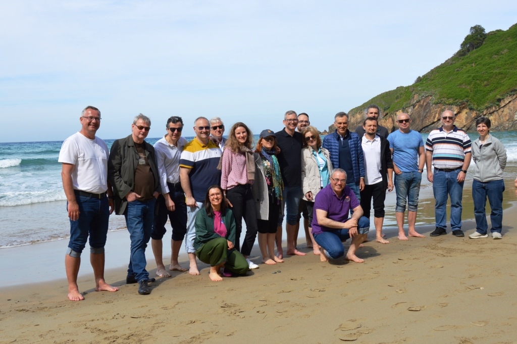 grupa osób pozujących do zdjęcia na plaży