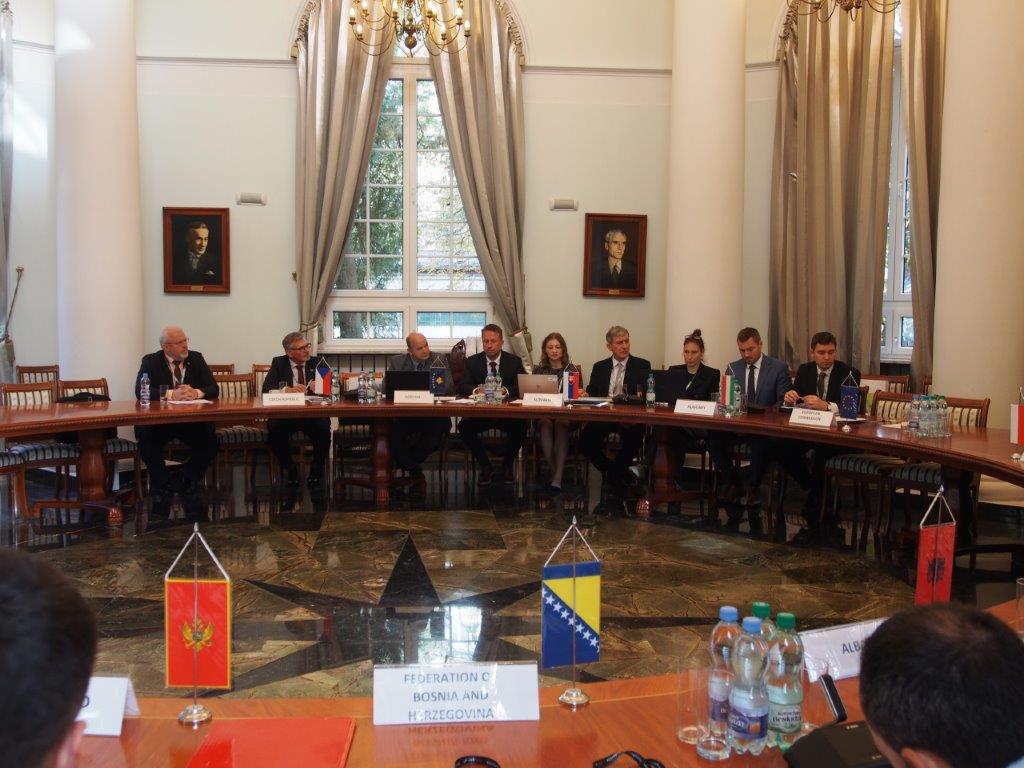 grupa osób siedząca przy okrągłym stole