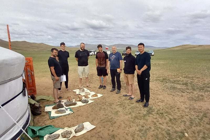 Looking through collected rock samples in Mongolia (R. Pachytel)